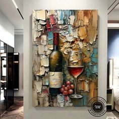 a painting on the wall with a bottle and wine glass next to it, in front of a bed