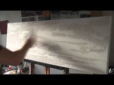 a man is working on a large white board