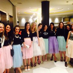 a group of young women standing next to each other in front of a lobby area