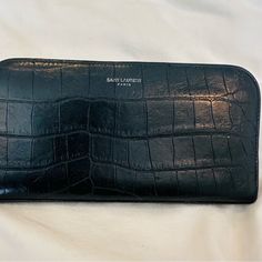 Euc-Saint Laurent- Black Croc Embossed Leather Zip Around Wallet. Six Card Slots On Both Sides And Additional Space For Money With Separate Change Zipper. Both Zippers Fully Work. Some Rubbing On Leather To Corners And Edges Please Refer To All Pics. Size (Approx) Length 20.5 Cm / 8.1 Inches Height 10 Cm / 3.9 Inches Elegant Textured Leather Rectangular Wallet, Elegant Textured Leather Wallet, Designer Formal Wallet In Textured Leather, Elegant Black Clutch With Textured Leather, Silver Leather Evening Wallets, Evening Silver Leather Wallets, Elegant Black Textured Leather Clutch, Elegant Leather Wallet For Everyday Use, Black Leather Clutch For Everyday Luxury