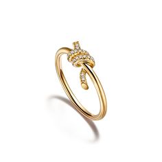 Tiffany Knot is an expression of love’s unwavering bonds. Inspired by an archival bow crafted in 1889, Knot is a symbol of life’s most enduring ties and meaningful connections. This ring is crafted with yellow gold and pavé diamonds, then polished by hand for high shine. Each round brilliant diamond—specifically chosen to meet Tiffany’s high standards—is hand set at precise angles to maximize brilliance. Wear this ring on its own or partnered with classic silhouettes for an unexpected pairing. Tiffany Diamond Ring Tiffany & Co., Tiffany Band Ring, Tiffany Sixteen Stone Ring, Gold Tiffany Ring, Tiffany And Co Gold Ring, Gold Tiffany Jewelry, Tiffany Setting Tiffany & Co., Tiffany Ring Gold, Tiffany Engagement Ring Gold