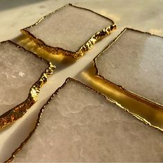 four pieces of gold foil sitting on top of ice