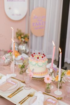 a table topped with a cake covered in frosting