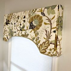 a window valance with flowers and leaves on it