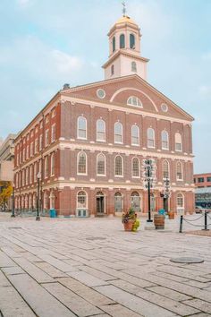 an old brick building with a clock tower in the middle of it's center