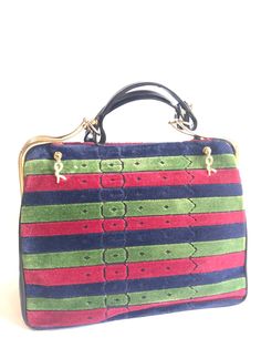 "For all Roberta vintage lovers, this handbag is the one for you! 70s-80s, one-of-a-kind beautiful purse by Roberta di Camerino.... Featuring its iconic tricolor in red, navy, and green stripe design on both sides and golden \"R\" dangling charms. Normal sign of use and age with some scuffs and scratches. The golden brass shows some tarnishing partially. Some scratches and scuffs are seen in the interior linings. No wears are seen on the handles and corners. Overall, it is still in a good vintag Green Vintage Top Handle Satchel, Vintage Green Satchel For Shopping, Vintage Green Satchel For Formal Occasions, Vintage Green Formal Satchel, Green Retro Formal Bags, Retro Multicolor Evening Bag, Retro Green Evening Bags, Retro Multicolor Shoulder Bag For Evening, Retro Multicolor Evening Shoulder Bag