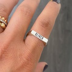 "This rectangular shaped traditional signet style ring is composed of 14K solid gold & can be finished with any name, word, initials, Roman numerals or monogram initials desired. This ring is entirely solid (NOT hollowed out on the inside) making is also possible for gemstone setting. NOTE: Please indicate the font style for engraving desired in the 'Note to Seller' section upon checkout. We will also gladly send a mock-up rendering of the engraving prior to purchasing the item by kindly sending Adjustable Sterling Silver Engraved Ring Stamped 14k, Modern Personalized 14k Gold Engraved Ring, Classic Engraved Rectangular Initial Ring, Open Band Polished Signet Promise Ring, Open Band Signet Promise Ring With Polished Finish, Signet Open Band Ring For Promise, Polished Open Band Promise Signet Ring, Modern Personalized Open Ring Jewelry, Classic Engraved Rectangular Jewelry