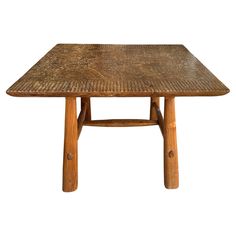 a table made out of wood and wicker with one leg bent down to the side