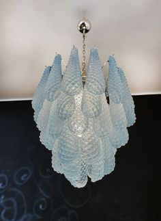 a glass chandelier hanging from a ceiling