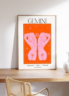 an orange and pink poster with the words gemin on it in front of a chair