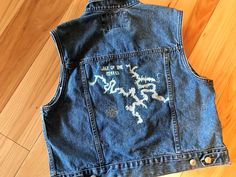 an old jean vest with writing on it