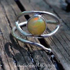 Handmade, Natural Faceted Ethiopian Opal Sterling Silver Evil Eye Ring Size 8* (read sizing information below)  💕Featured in this listing is a sterling silver, handmade, natural stone ring.  This lovely ring features a beautiful, Natural Rainbow Ethiopian Opal stunning round stone that is super colorful, bezel set as the center of an eye in this handmade wrap style ring.    💕Made of all Sterling Silver, and is adjustable,  I'm happy to adjust for you prior to shipping, can easy fit a size 7 up Handmade Sterling Silver Opal Promise Ring, Adjustable Nickel-free Sterling Silver Opal Ring, Handmade Sterling Silver Opal Ring, Handmade Adjustable Opal Ring, Handmade Unique Sterling Silver Opal Ring, Unique Nickel-free Round Opal Ring, Unique Sterling Silver Opal Ring Birthstone, Unique Sterling Silver Open Opal Ring, Unique Handmade Opal Ring