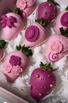 pink chocolate covered strawberries in a box with flowers and pearls on the top, sitting next to each other