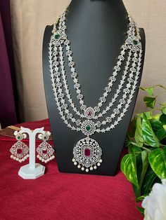 Grand Haram AD Diamond Ruby Emerald Doublet Stone/Bridal Haram/34 Inches Long Haram Ruby Stone/ Detachable pendant /South Indian jewelry This item is perfect for parties and festivals!  ITEM DETAILS: Handmade jewelry  Includes One Long Haram and Two Earrings. Necklace: 34.0 inches.total 34 inches long Wide 2.9 Pendent   Adjustable length. chain closure. Weighs 6.66oz (105 g).  Earrings:2.8 inch(es) long. Earring set weighs 0.75 oz (188g). Earring backs push on/off. Material: Imitation Micro gold Wedding Necklace With Detachable Cubic Zirconia Pendant, Silver Bridal Necklace With Detachable Pendant For Wedding, Diamond Necklace With Detachable Pendant For Wedding, Silver Bridal Necklace With Detachable Pendant For Celebration, Wedding Jewelry With Detachable Diamond Pendant, Detachable Pendant, Long Haram, Long Earring, South Indian Jewelry