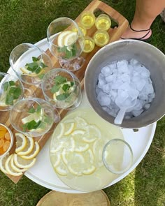 a platter filled with lemons, water and ice