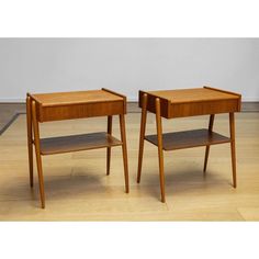 two small wooden tables sitting next to each other on a hard wood flooring area