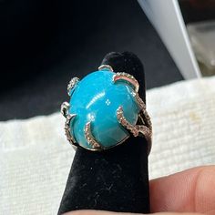 Nwot Look At This Beauty!!! Size 6, Large Cabochon Turquoise Set In 925 Ss Gold Tone, Surrounded By Rhinestones. You Will Not Find Another Ring Like This One. The Turquoise Has Been Scratch Tested And Acetone Tested For Purity. Turquoise Is A Semi-Translucent To Opaque Gem That Ranges From Blue To Green. A Mineral That Is Hydrous Phosphate Of Copper And Aluminum, With The Chemical Formula Cuai6 4 8 4h20. Formal Turquoise Diamond Ring With Gemstone, Formal Turquoise Diamond Ring, Elegant Turquoise Cabochon Diamond Ring, Luxury Turquoise Cabochon Ring, Formal Fine Jewelry Turquoise Ring With Accent Stones, Gift Diamond Turquoise Cabochon Ring, Blue Oval Cabochon Jewelry With Gemstone Accents, Blue Oval Cabochon Gemstone Jewelry, Blue Diamond Turquoise Ring With Cabochon