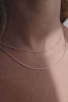 Sleek and minimal, this 1mm thick snake chain is great for layering with other necklaces. Add a pendant to it or wear it by itself. - Sterling Silver or 14K Gold-Filled - 16" or 18" long Jewelry Care All items, excluding one-of-a-kind and ready-to-ship pieces, are Made to Order and take 1-4 weeks to process before shipping. Items currently in stock will ship within 1-5 business days. All items are final sale. Please confirm your ring size before purchasing. Minimal Necklace Silver, Minimal Necklace, Dainty Chain, Jewelry Inspo, Snake Chain, Jewelry Care, Silver Necklaces, Silver Chain, Final Sale