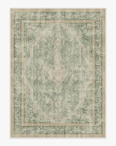 a green and beige rug with an intricate design on the center, in front of a white background