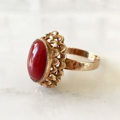 Details: Stunning vintage 14K gold Coral ring. It is a beautiful stone, and setting with lots of detail and life in it. The ring is in excellent condition with no visible flaws. Please ask all necessary questions prior to placing an order. Measurements: The size is 5 3/4 US and can be sized for a fee. The coral measures 13mm x 9mm, and has a depth of 2.2mm. Condition: The overall all condition of this ring is excellent. Vintage Red Oval Cabochon Signet Ring, Vintage Red Signet Ring With Oval Cabochon, Antique Red 14k Gold Signet Ring, Antique Red Signet Ring In 14k Gold, 14k Gold Red Cabochon Ring, 14k Gold Cabochon Red Ring, 14k Gold Rings With Red Cabochon, Vintage Red Cabochon Ruby Ring, Heirloom Red Ruby Cabochon Ring