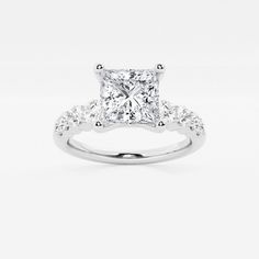 a princess cut diamond engagement ring with side stones on the band and shoulders set in 18k white gold