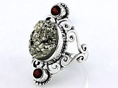 Artisan Collection of India™  12.98ct Oval Pyrite & 0.40ctw Round Garnet Sterling Silver Ring. Measures Approximately 0.81"L x 1.24"W. Not Sizeable. Luxury Silver Gemstones For Wedding, Formal Fusion Rings With Accent Stones, Formal Fusion Style Rings With Accent Stones, Fusion Oval Jewelry With Accent Stones, Fusion Multi-stone Jewelry For Anniversary, Polished Silver Gemstones For Anniversary, Unique Polished Gemstones For Formal Occasions, Silver Gemstones With Polished Finish For Anniversary, Fusion Style Multi-stone Jewelry For Anniversary