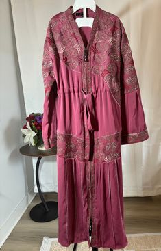 abaya for muslim girls. Comes with a hijab Traditional Pink Maxi Length Abaya, Traditional Pink Floor-length Abaya, Traditional Floor-length Pink Abaya, Traditional Long Pink Abaya, Long Pink Dress For Eid, Pink Long Dress For Eid, Modest Maxi Dress For Festive Occasions, Eid Tunic Dress With Dabka Details, Dabka Tunic Dress For Eid