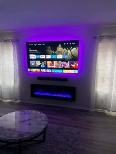 a flat screen tv mounted to the side of a wall next to a fire place