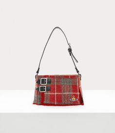 Our novelty Heather Kilt bag echoes the silhouette of the archive mini kilt, first worn by Kate Moss in the Autumn-Winter 1993/94 'Anglomania' collection. The design features romantically clashing clan tartans, complete with a classic safety pin and dangle orb pierced through the bag - evoking Vivienne’s signature Punk aesthetic. Red Vivienne Westwood, Vivienne Westwood Tartan, Vivienne Westwood Purse, Clan Tartans, Eastpak Backpack, Punk Aesthetic, Womens Designer Bags, Red Bag, Woman Bags Handbags