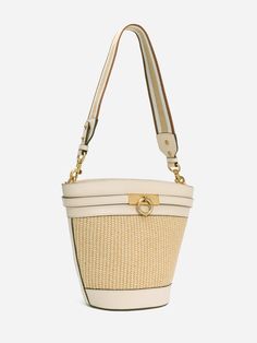 The timeless, trend-setting design of the Unlocked Bucket Bag is simply a must-have. This bag was crafted with full-grain smooth calfskin. Wear it by its adjustable, removable shoulder strap or elegantly draped over your shoulder with an alternative woven strap. With a spacious interior, it is a wardrobe staple for your everyday adventure. - Full-grain smooth calfskin leather from USA - Matching color leather interior - One internal slip pocket - One adjustable leather shoulder strap and one wov Luxury Natural Straw Bag With Removable Pouch, Evening Bucket Bag With Braided Handles, Elegant Leather Handles Shoulder Bucket Bag, Formal Spring Tote Shoulder Bag, Beige Bucket Satchel With Adjustable Strap, Classic Cream Satchel Bucket Bag, Elegant Bucket Hobo Bag With Detachable Handle, Elegant Bucket Bag With Detachable Strap And Double Handle, Elegant Satchel Bucket Bag With Detachable Strap