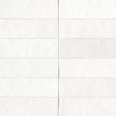 a white tiled wall with lines drawn on the bottom and one line in the middle