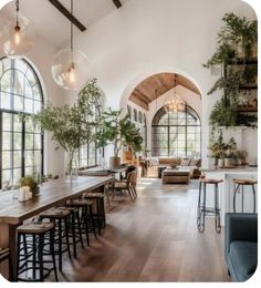 a living room filled with lots of furniture and large windows next to a dining table