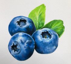 three blueberries with green leaves on white paper