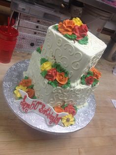 a three tiered white cake with flowers on it