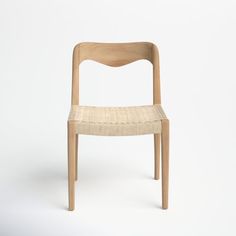 a wooden chair sitting on top of a white floor