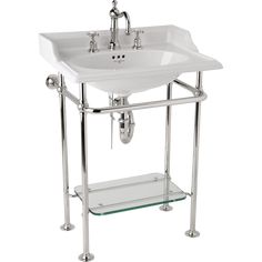 a white sink sitting on top of a metal stand