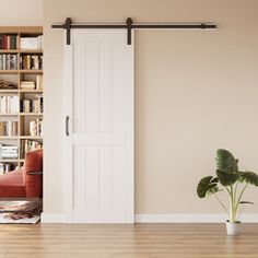 a living room with an open door and bookshelves