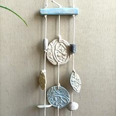 a wind chime hanging from the side of a wall