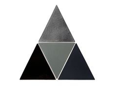 a triangle shaped object with black, grey and white triangles in the center on a white background