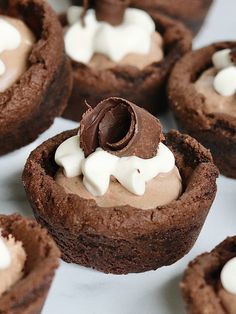 chocolate cupcakes with whipped cream on top