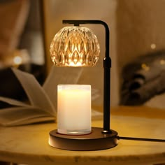 a table lamp with a lit candle on it