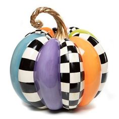 three colorful pumpkins are stacked on top of each other in the shape of checkers