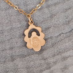 Featuring a stunning floral pattern, our Midi Miraculous Medal Necklace is a medium-sized companion to our Mini Miraculous Medal Necklace and Large Miraculous Medal Necklace. Compared to our original Miraculous Medal Necklace, this piece offers a distinct + intricate design, slightly heavier medal weight, and enhanced overall build quality. Simple and beautiful, the Miraculous Medal Necklace was created to help spread the extraordinary graces offered by this wonderful gift from our Blessed Mothe Medallion Necklace With Flower Charm For Anniversary, Anniversary Medallion Necklace With Flower Charm, Rose Gold Engraved Flower Necklace, Rose Gold Engraved Flower Shaped Necklace, Wedding Tarnish Resistant Flower Pendant Necklace, Rose Gold Flower-shaped Engraved Necklace, Engraved Rose Gold Flower-shaped Necklace, Yellow Gold Miraculous Medal Necklace As Gift, 14k Gold Miraculous Medal Necklace For Anniversary