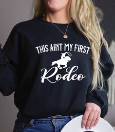 .This aint my first rodeo sweatshirt. ---------------------------------------------------------- Material: 80% ringspun cotton/20% polyester. - Drop shoulder style. - Stylish fit. - Soft cotton faced fabric. - Taped neck. - Ribbed collar, cuffs and hem. - Twin needle stitching. - WRAP Certified Production. Weight: 280 gsm -------------------------------------- Our entire shop here  https://etsy.me/3d9lkzC  This aint my first rodeo sweatshirt, cowgirl shirt, not my first rodeo, howdy yall, Wild West Country shirt, Nashville tee, yee haw shirt,       * please note, this design is created by myself using graphic design software, we use a production partner to help us print and ship to our UK and USA locations...this enables access to the BEST large scale printers in the world, cuts our produc Pre-shrunk Tops For Rodeo In Fall, Western Crew Neck Tops With Letter Print, Western Style Crew Neck Top With Letter Print, Western Style Letter Print Crew Neck Tops, Not My First Rodeo, My First Rodeo, First Rodeo, Santa Sweatshirt, Cowgirl Shirts