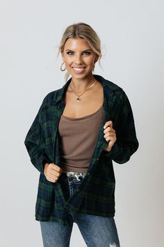 We guaranteed you'll want to wear our cute green 'Wait List' top year after year with its soft lightweight material, navy plaid print, button down front with a collared neckline, long loose sleeves with button closure cuffs, single accent chest pocket, and relaxed silhouette that falls into a straight front hemline and a rounded back hem!   Measurements S variant has  a Bust of 52",  a Hip of 53",  a Length of 24",  a Sleeve Length of 26",  a Waist of 53".  M variant has  a Bust of 54",  a Hip o Green Relaxed Fit Button-up Flannel Shirt, Green Long Sleeve Flannel Shirt For Work, Green Long Sleeve Flannel Shirt With Button Closure, Green Collared Flannel Shirt For Fall, Green Flannel Shirt With Button Closure For Fall, Green Casual Flannel Shirt With Button Closure, Green Button-up Flannel Shirt, Casual Green Flannel Shirt With Button Closure, Casual Green Button-up Flannel Shirt