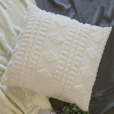 a white pillow sitting on top of a bed