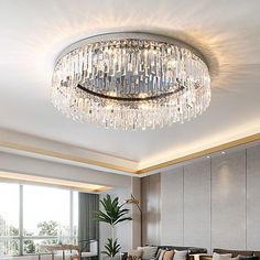 a living room filled with lots of furniture and a chandelier hanging from the ceiling