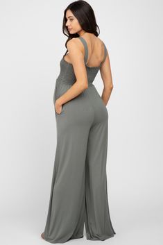 A sleeveless maternity jumpsuit featuring a smocked bust, side pockets, and wide legs. The Olive Sleeveless Wide Leg Maternity Jumpsuit is perfectly bump-friendly! Casual Strapless Sleeveless Jumpsuit With Elastic Waistband, Casual Strapless Jumpsuit With Elastic Waistband, Sleeveless Solid Jumpsuits And Rompers With Smocked Bodice, Solid Sleeveless Jumpsuit With Smocked Bodice, Casual Sleeveless Jumpsuits And Rompers With Elastic Back, Solid Color Sleeveless Jumpsuit With Smocked Bodice, Casual Sleeveless Jumpsuit With Elastic Back, Sleeveless Jumpsuits And Rompers For Loungewear With Smocked Back, Sleeveless Jumpsuits And Rompers With Smocked Back For Loungewear