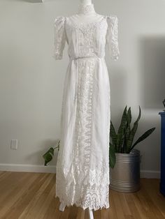 Stunning vintage 70s handmade cottagecore/prairie/boho wedding maxi dress. Beautiful mesh top with high neck and lace aplique throughout the entire dress. The outer part of the dress seems to be made of cotton fabric and is lined with polyesters from the bust all the way down to the bottom hem. The dress is missing it's original belt, but is otherwise in great vintage condition with no noted flaws such as missing buttons, stains or holes.  No size tag, but would best fit a modern Small to Medium Bohemian Victorian Dress With Lace Trim For Wedding, Bohemian Victorian Wedding Dress With Lace Trim, Vintage Lace Maxi Dress With Lace Trim, Vintage Lace Maxi Dress For Garden Party, White Lace Cottagecore Vintage Dress, Bohemian Vintage Wedding Dress With Lace Trim, Bohemian Vintage Dress With Lace Trim For Vintage-themed Events, Vintage Lace Maxi Dress For Wedding, Cottagecore Victorian Dress For Summer Weddings