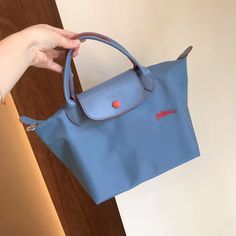 Longchamp Le Pliage Club 70th S Haze Blue Women's Handbag Canvas Tote Small Foldable Dimensions : 9.1 In (L - Measured At The Base Of The Bag) X 8.7 In (H) X 5.5 In (W) Material : Polyamide Fabric With A Minimum Of 70% Recycled Fibre, With Inner Coating Trimming : Leather (Cowhide) Closing : Zipped And Snap Closure Handle Height : 9 Cm / 3.5 In Classic Light Blue Shoulder Bag For Travel, Classic Blue Bags With Handles, Light Blue Travel Bag With Detachable Strap, Classic Light Blue Travel Bag, Classic Blue Bag With Snap Closure, Classic Blue Shoulder Bag For Travel, Blue Everyday Bags With Snap Closure, Blue Bag With Snap Closure For On-the-go, Blue Shoulder Bag With Snap Closure